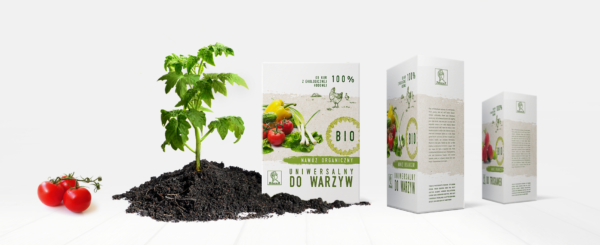 pudełka papierowe z nawozem organicznym marki Athena, obok sadzonka pomidora