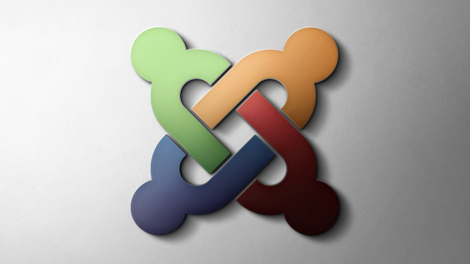 Grafika przedstawiająca kolorowe logo Joomla na szarym tle