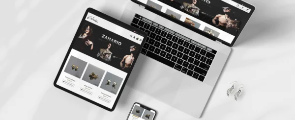 laptop, tablet i smartphone z otwartym sklepem internetowym Zahario, obok kolczyki