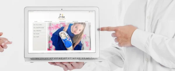 mężczyzna wskazuje laptop z otwartym sklepem internetowym Zuzy