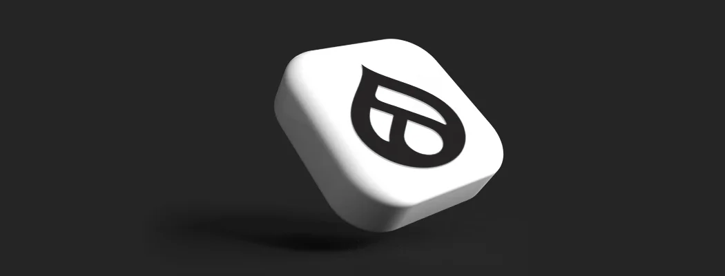 Trójwymiarowa biała ikona przedstawiająca czarne logo systemu CMS Drupal.