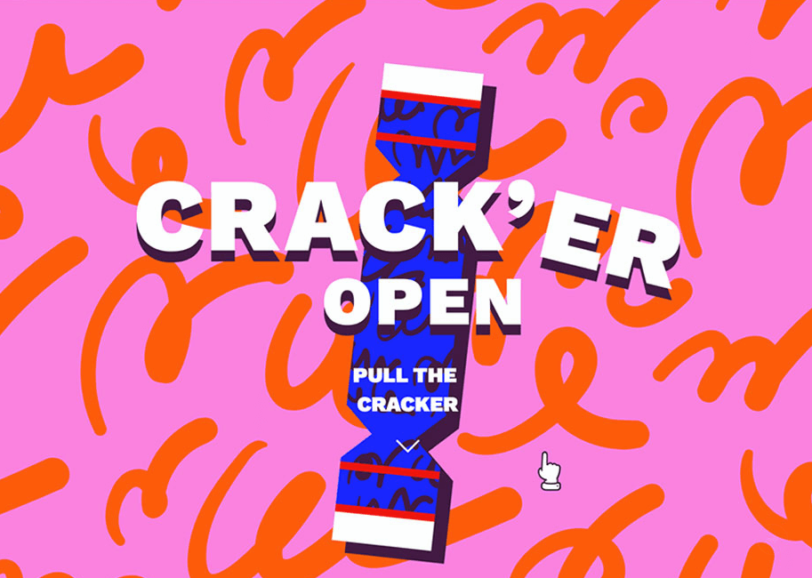 Kolorowy interaktywny baner świąteczny z napisem Crack'er Open i grafiką niebieskiego cukierka na różowym tle