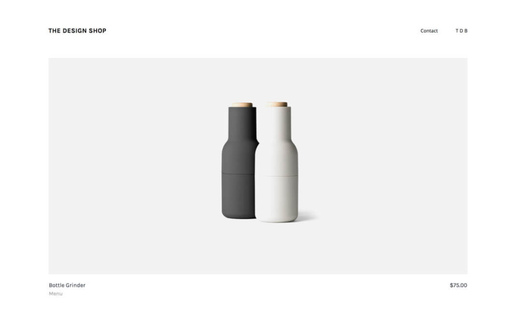 Minimalistyczna strona produktowa The Design Shop przedstawiająca zestaw nowoczesnych młynków do soli i pieprzu Bottle Grinder marki Menu