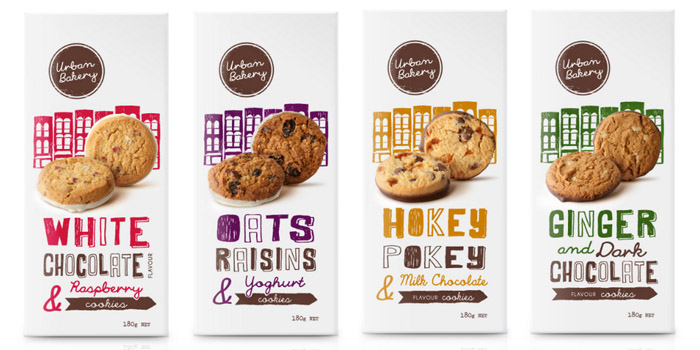 Cztery opakowania ciastek Urban Bakery z ilustracjami budynków i wyrazistą typografią
